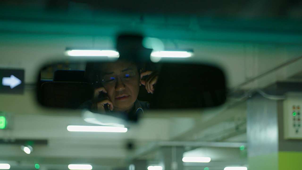 a person's reflection in the rearview mirror